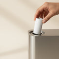 Mewra Pure Filter activated carbon cartridge being inserted into a stainless steel cat fountain